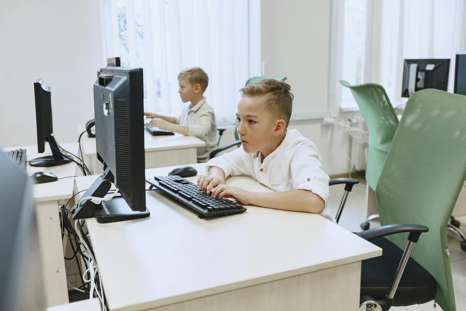 Boys working on computers in a classroom